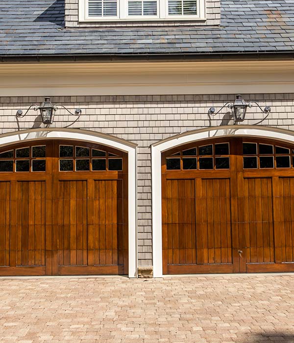 Stained wood custom garage doors for large southern home